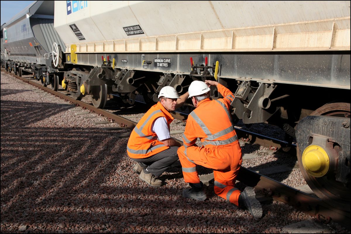 Inspecting Goods Rail Trucks: Swipe To View More Images